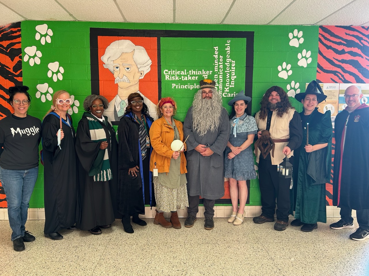 a photo Twain leadership dressed up as members of the Hogwarts faculty and students